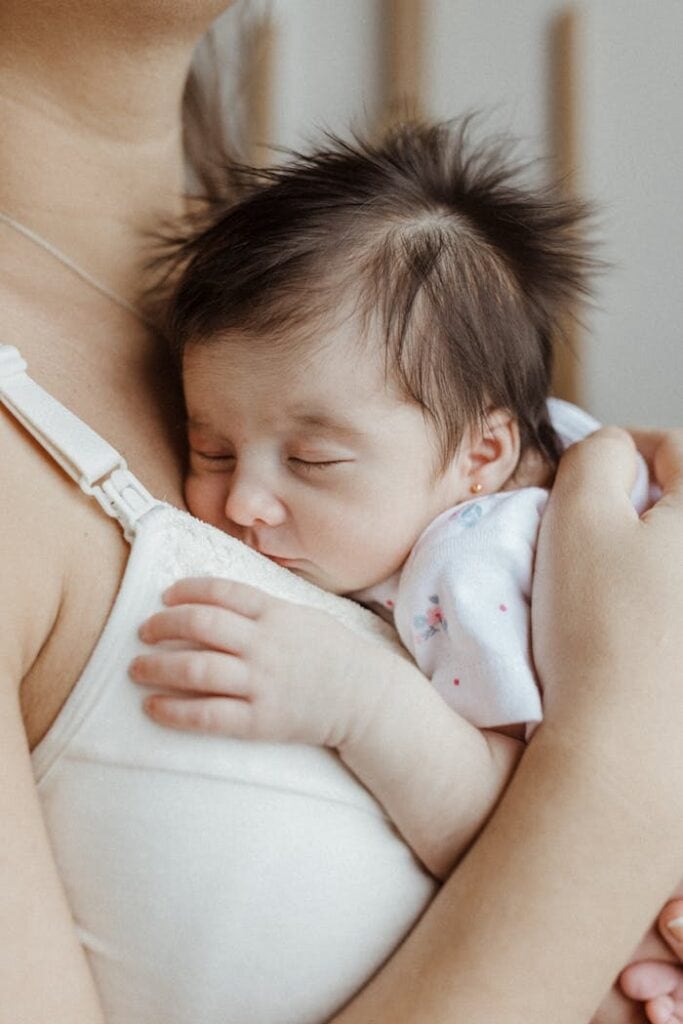 A woman holding a baby in her arms